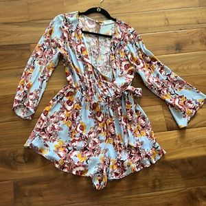Aster floral romper size M. Adorable on and has no rips, tears or stains